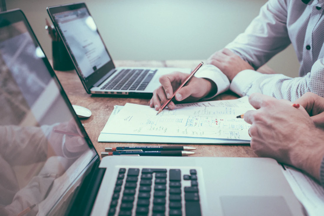 Finance professionals reviewing accounts on a laptop